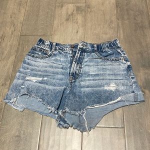 Purposely ripped blue jean shorts